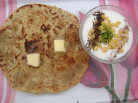 Here's your delicious Rajma Paratha. Top it up with butter and enjoy with raita or coriander chutney/sauce.